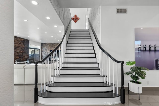 staircase featuring tile patterned floors