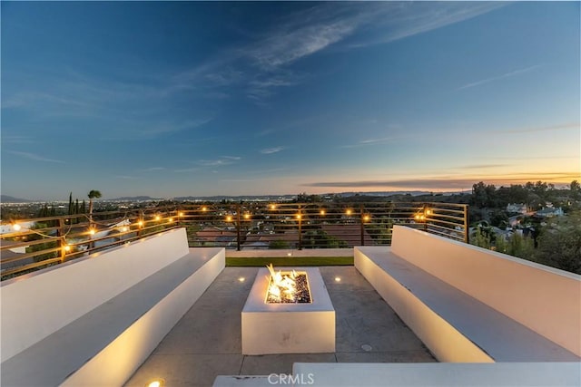 patio terrace at dusk with an outdoor fire pit