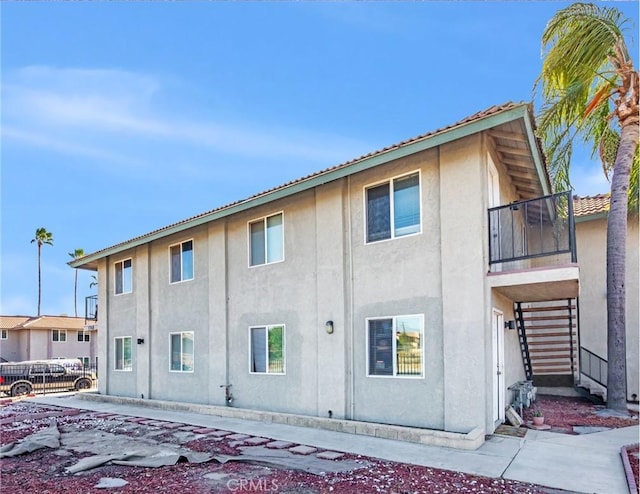 rear view of property with a balcony