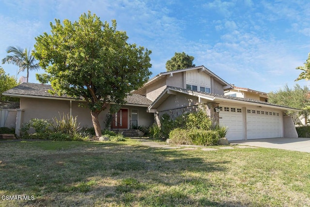 view of front of property featuring a front yard and a garage