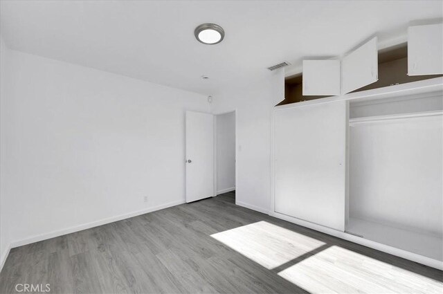 spare room with light wood-type flooring