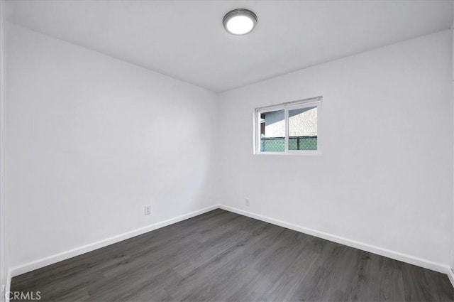 empty room featuring dark hardwood / wood-style flooring