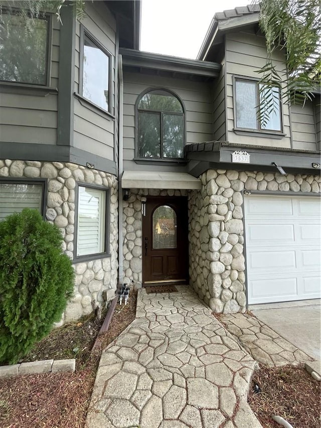 view of exterior entry featuring a garage