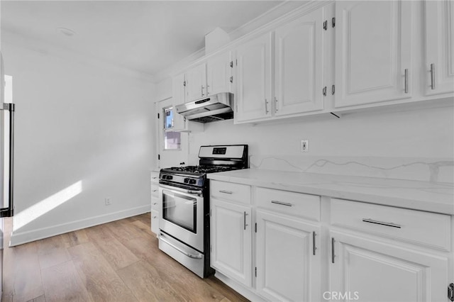 kitchen featuring white cabinets, stainless steel gas range oven, ornamental molding, and light hardwood / wood-style flooring