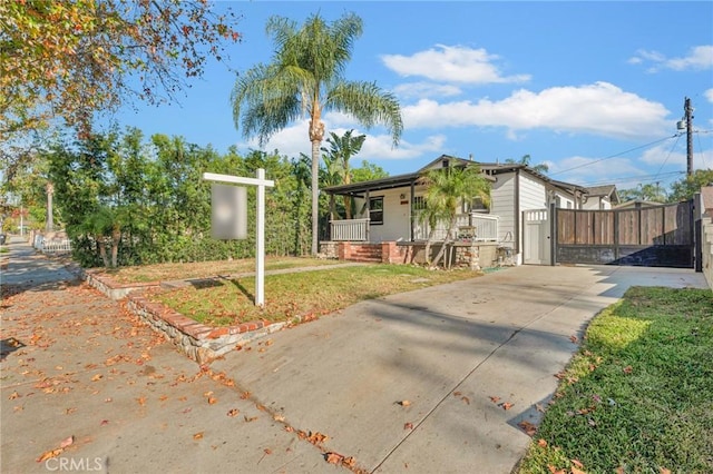 view of front of home with a porch and a front yard