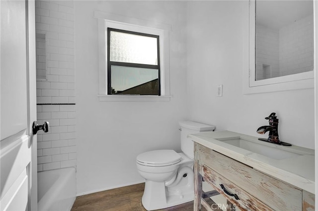 bathroom featuring hardwood / wood-style flooring, vanity, and toilet