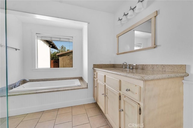 bathroom featuring tile patterned flooring, vanity, and a bath