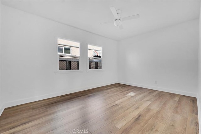 spare room featuring light hardwood / wood-style flooring and ceiling fan