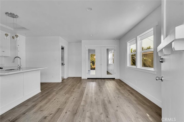 foyer with light hardwood / wood-style floors and sink