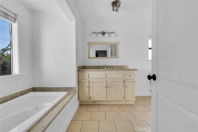 bathroom with vanity, tile patterned floors, and a tub