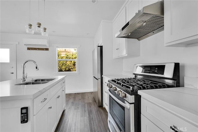 kitchen featuring white cabinets, sink, wall chimney exhaust hood, and stainless steel appliances