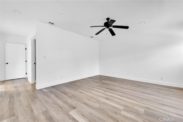 empty room with light hardwood / wood-style flooring and ceiling fan