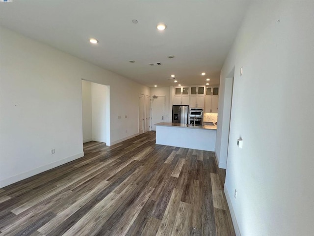 unfurnished living room with dark hardwood / wood-style flooring