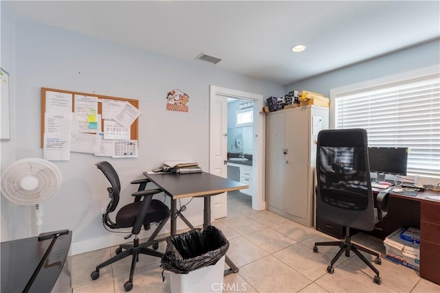 office space with plenty of natural light and light tile patterned floors