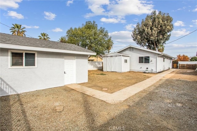 view of side of home featuring a storage unit