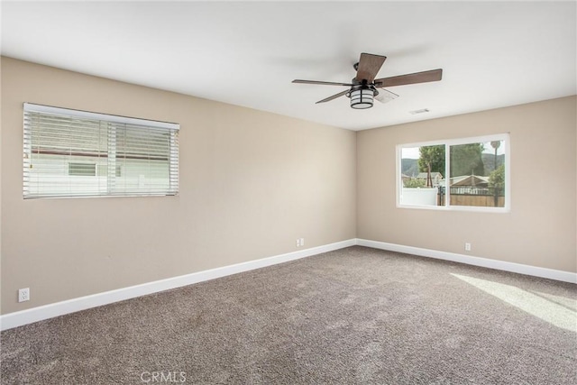 carpeted spare room with ceiling fan