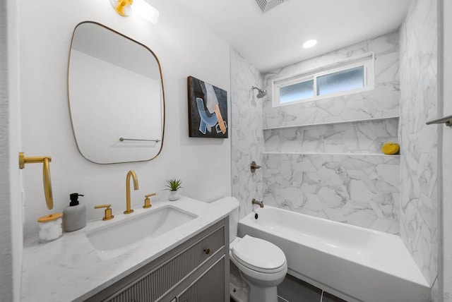 full bathroom featuring toilet, tile patterned flooring, tiled shower / bath, and vanity