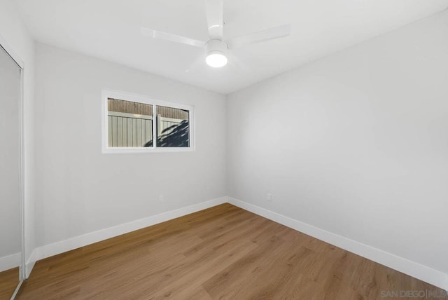 spare room with ceiling fan and wood-type flooring