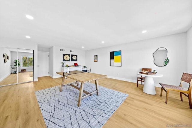 game room with light wood-type flooring