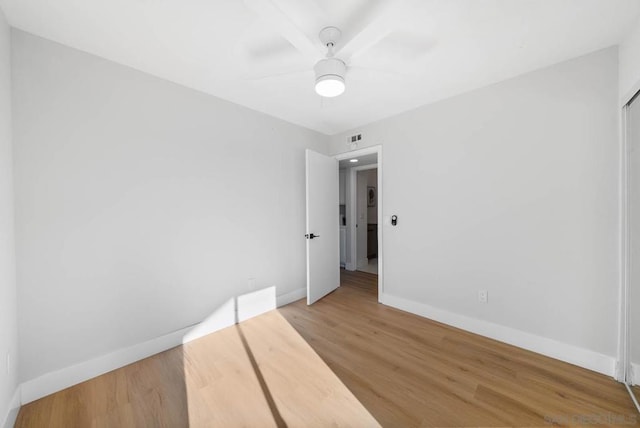 unfurnished room featuring ceiling fan and hardwood / wood-style flooring