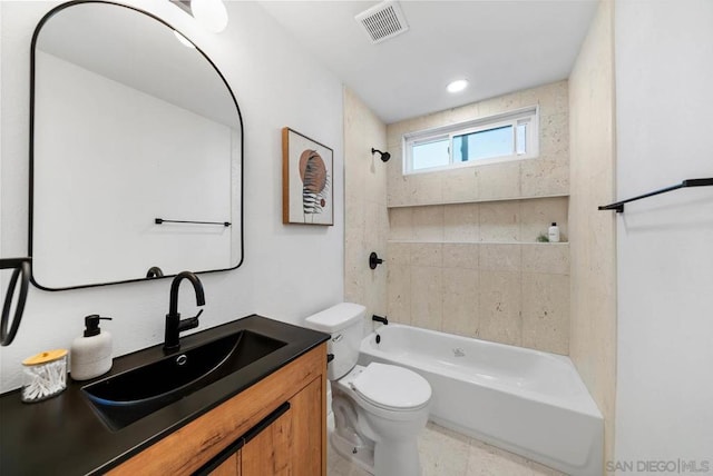 full bathroom featuring toilet, vanity, and tiled shower / bath