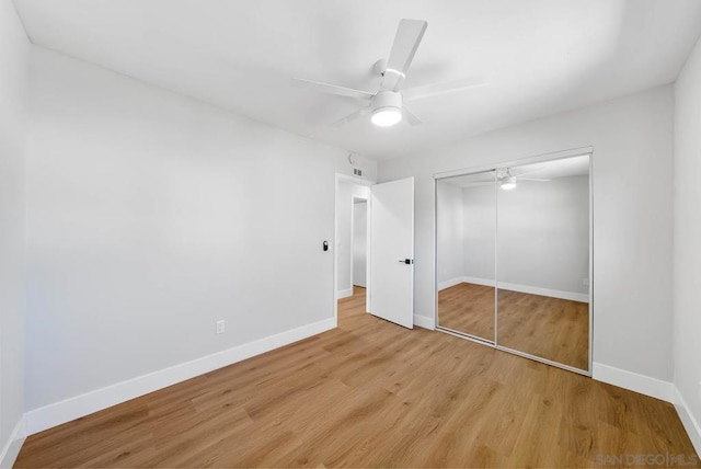 unfurnished bedroom with ceiling fan, a closet, and light hardwood / wood-style flooring