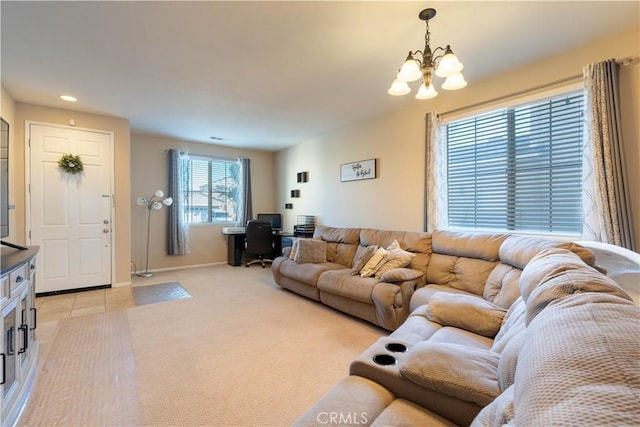 living room with an inviting chandelier and light colored carpet