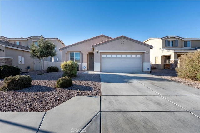 mediterranean / spanish house featuring stucco siding, a garage, concrete driveway, and a tile roof