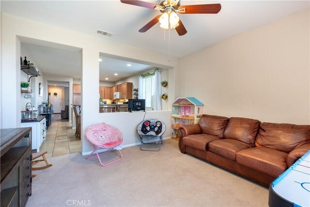 living room with light colored carpet and ceiling fan