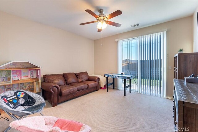 living room featuring ceiling fan and light carpet