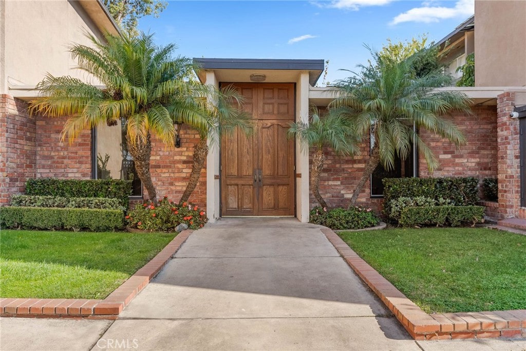 doorway to property featuring a yard