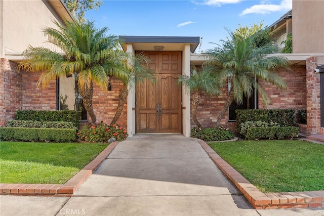 doorway to property featuring a yard