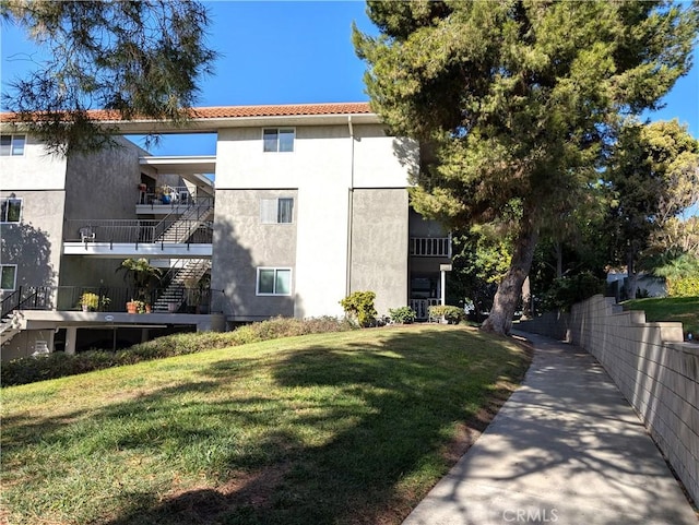 view of side of property with a yard