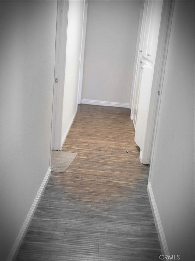 hallway with dark hardwood / wood-style floors