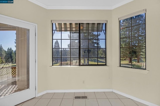 interior space featuring plenty of natural light, light tile patterned floors, and crown molding