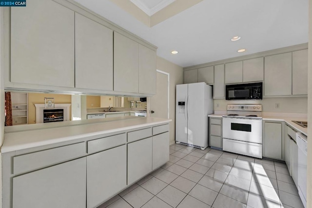 kitchen featuring sink, white appliances, crown molding, and light tile patterned flooring