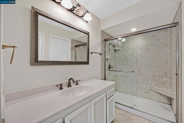 bathroom featuring vanity, tile patterned floors, and walk in shower