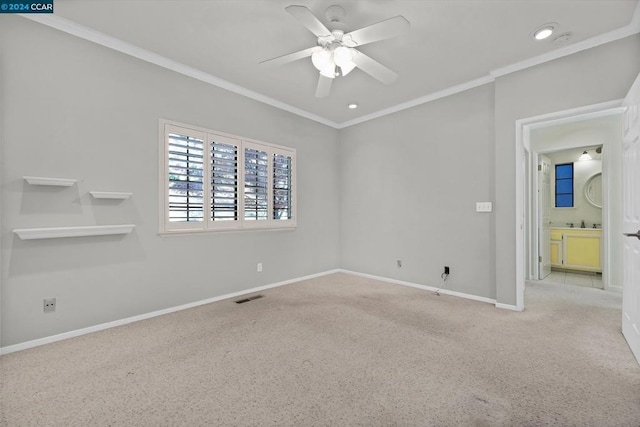 unfurnished bedroom featuring light colored carpet, ceiling fan, ornamental molding, and ensuite bathroom