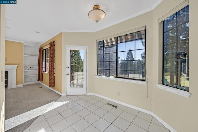 interior space with light tile patterned floors and ornamental molding