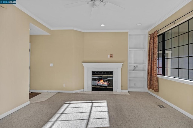 unfurnished living room with light carpet, a fireplace, crown molding, and ceiling fan