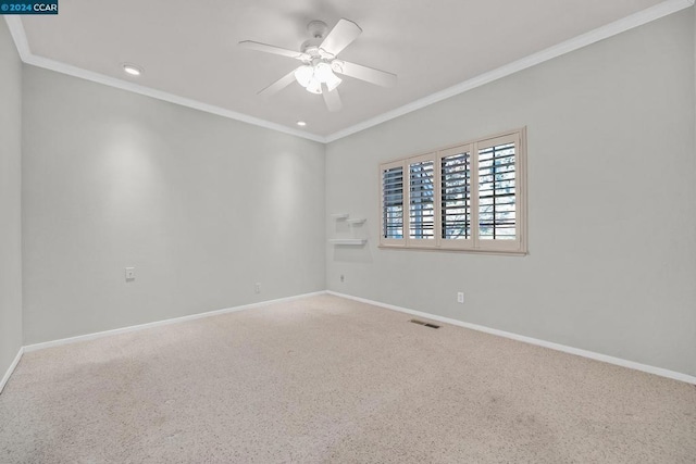 empty room featuring ceiling fan, carpet floors, and ornamental molding