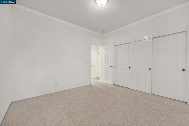 unfurnished bedroom featuring ornamental molding and a closet