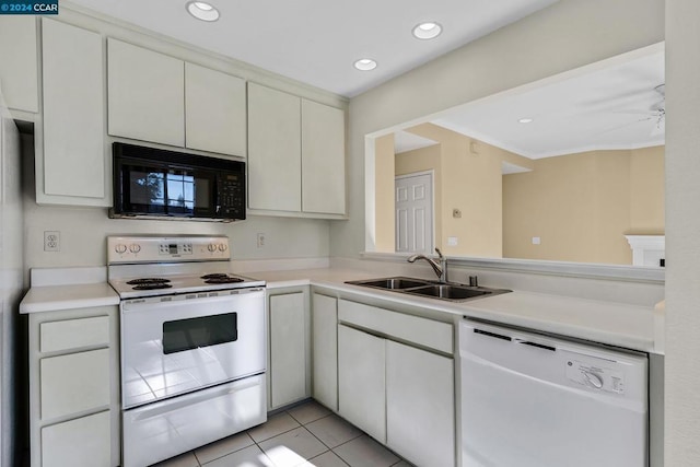 kitchen with white cabinets, white appliances, sink, and light tile patterned floors