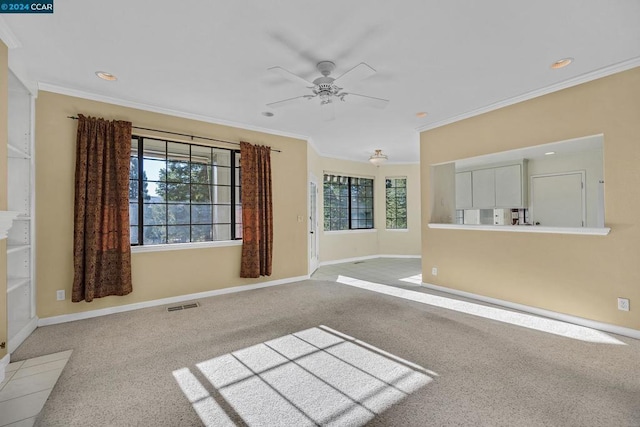 interior space featuring ceiling fan, crown molding, and light carpet