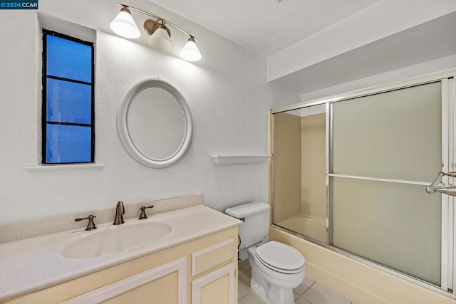 full bathroom featuring tile patterned flooring, vanity, bath / shower combo with glass door, and toilet