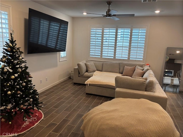 living room featuring dark hardwood / wood-style floors and ceiling fan