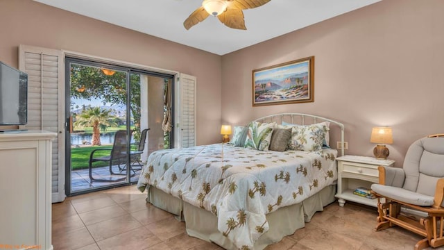 bedroom with ceiling fan, access to exterior, light tile patterned floors, and a water view