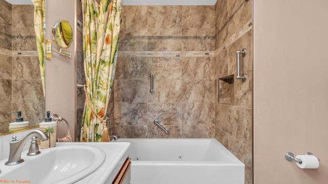 bathroom featuring shower / tub combo and vanity