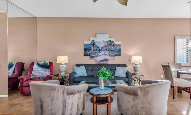 living room with ceiling fan and light tile patterned flooring