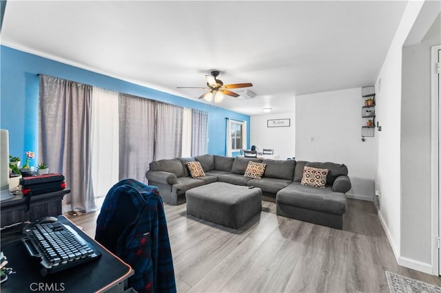 living room featuring ceiling fan and hardwood / wood-style flooring